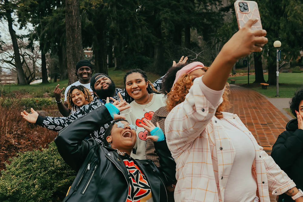 A group of BSC students posing together for a selfie, the student in front has her arm outstretched and her phone is in the frame