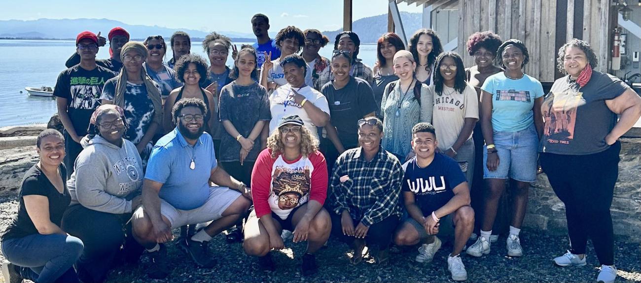 Students of the Black Student Coalition posed together next to a beach house