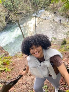 Tekhia taking a selfie next to a river